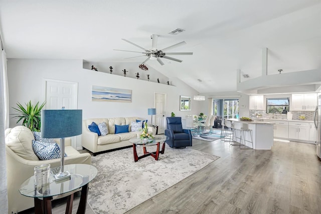 28 SW 21st Ave, Cape Coral, FL 33991 - living room with ceiling fan, light wood-style floors, and high vaulted ceiling