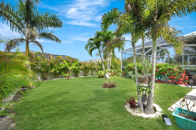 28 SW 21st Ave, Cape Coral, FL 33991 - view of grassy yard featuring glass enclosure