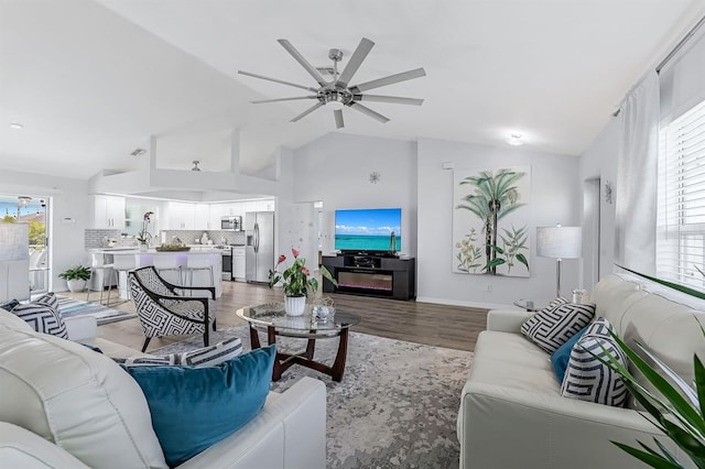 28 SW 21st Ave, Cape Coral, FL 33991 - living room with lofted ceiling, a ceiling fan, light wood-type flooring, and baseboards