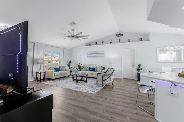 28 SW 21st Ave, Cape Coral, FL 33991 - living room with ceiling fan, vaulted ceiling, wood finished floors, and baseboards