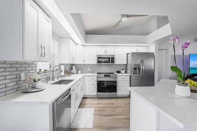 28 SW 21st Ave, Cape Coral, FL 33991 - kitchen with appliances with stainless steel finishes, a sink, white cabinets, backsplash, and light stone counters