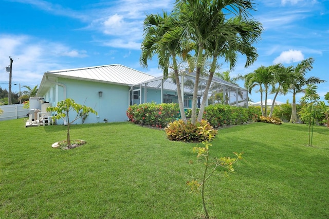 28 SW 21st Ave, Cape Coral, FL 33991 - view of property exterior featuring a standing seam roof, metal roof, glass enclosure, and stucco siding