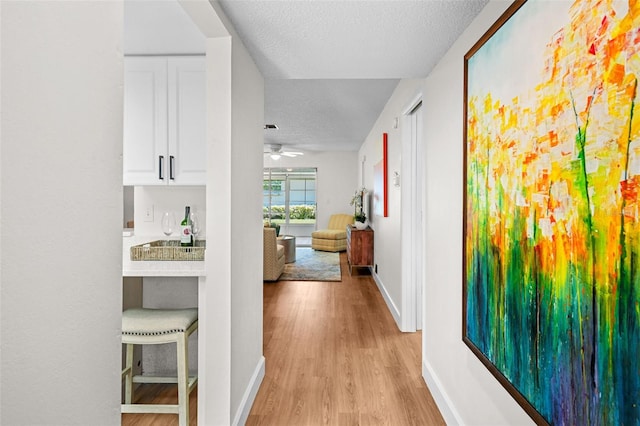 2460 Northside Dr Unit 802, Clearwater, FL 33761 - hallway with a textured ceiling and light wood finished floors