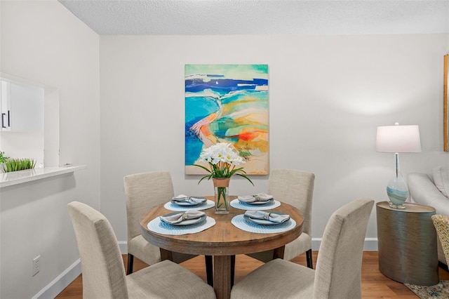 2460 Northside Dr Unit 802, Clearwater, FL 33761 - dining room featuring light wood finished floors and a textured ceiling