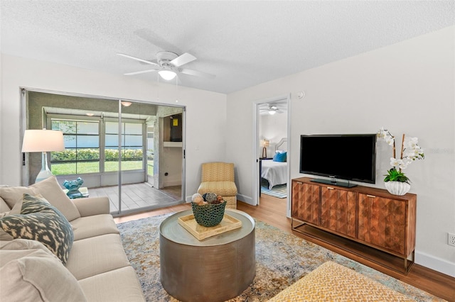 2460 Northside Dr Unit 802, Clearwater, FL 33761 - living area featuring ceiling fan, wood finished floors, and a textured ceiling