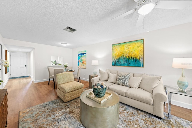 2460 Northside Dr Unit 802, Clearwater, FL 33761 - living room featuring wood finished floors, a ceiling fan, and a textured ceiling