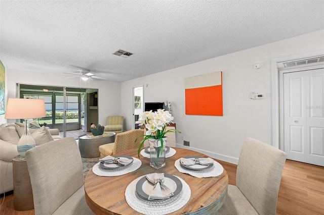 2460 Northside Dr Unit 802, Clearwater, FL 33761 - dining area with a textured ceiling, wood finished floors, and ceiling fan