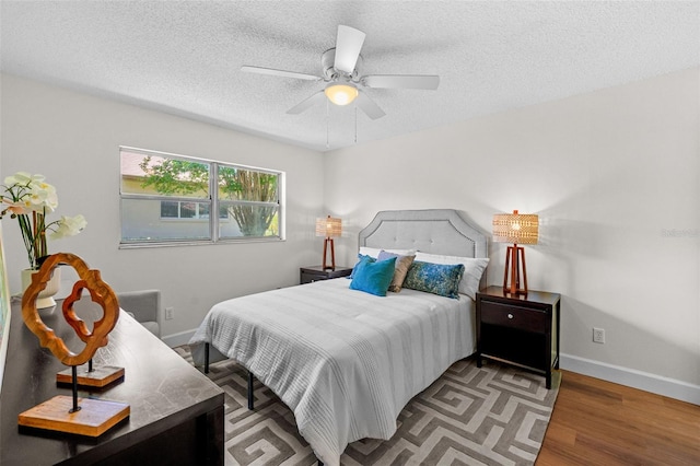 2460 Northside Dr Unit 802, Clearwater, FL 33761 - bedroom featuring wood finished floors, a textured ceiling, and ceiling fan