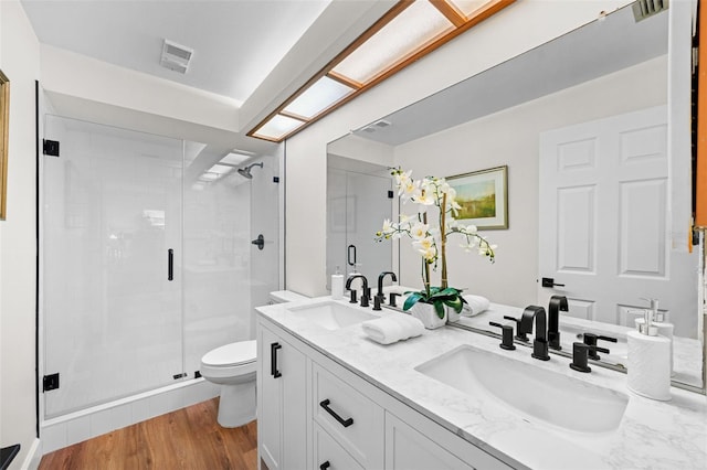 2460 Northside Dr Unit 802, Clearwater, FL 33761 - full bathroom with a stall shower, double vanity, and wood finished floors