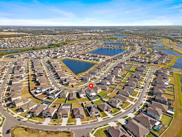 9334 Lemon Drop Loop, Sun City Center, FL 33573 - aerial view of property's location with nearby suburban area and a large body of water