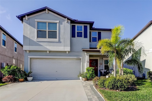 9334 Lemon Drop Loop, Sun City Center, FL 33573 - view of front of property with an attached garage, stucco siding, and concrete driveway