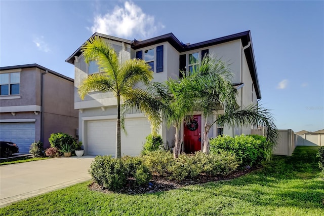 9334 Lemon Drop Loop, Sun City Center, FL 33573 - view of front of home with stucco siding, concrete driveway, and a garage