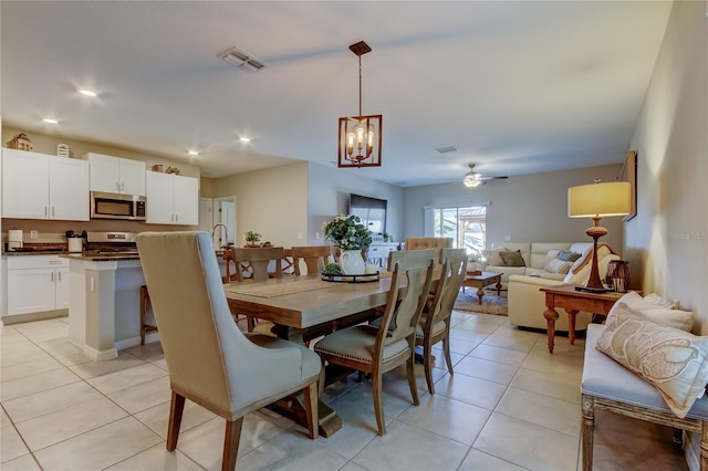9334 Lemon Drop Loop, Sun City Center, FL 33573 - dining space featuring ceiling fan, light tile patterned flooring, a chandelier, and recessed lighting
