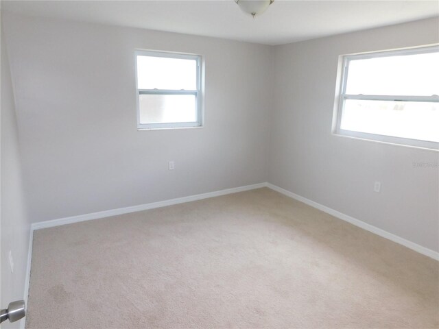 4417 Kohler St, New Port Richey, FL 34652 - carpeted empty room with healthy amount of natural light and baseboards