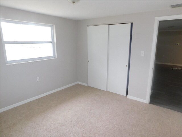 4417 Kohler St, New Port Richey, FL 34652 - unfurnished bedroom with light colored carpet, a closet, and baseboards