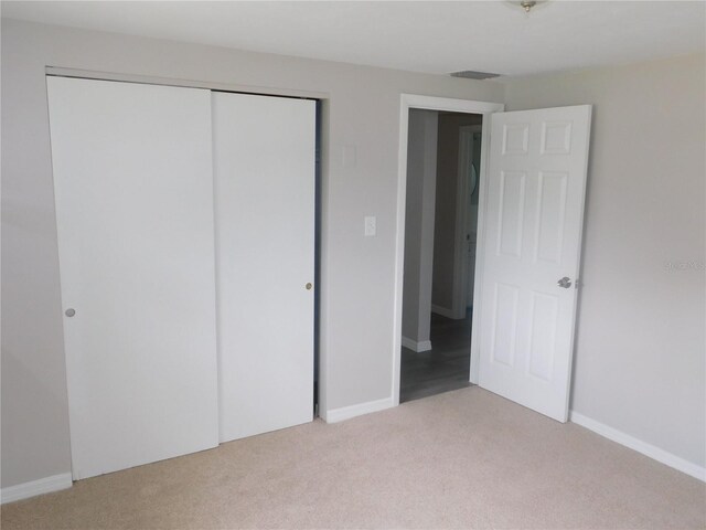 4417 Kohler St, New Port Richey, FL 34652 - unfurnished bedroom with light carpet, a closet, and baseboards