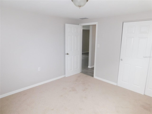 4417 Kohler St, New Port Richey, FL 34652 - unfurnished bedroom with carpet, baseboards, and a closet