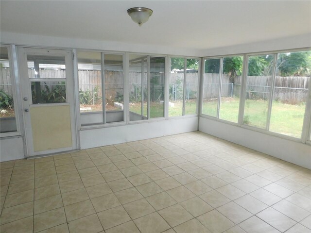 4417 Kohler St, New Port Richey, FL 34652 - unfurnished sunroom with plenty of natural light and tile patterned flooring