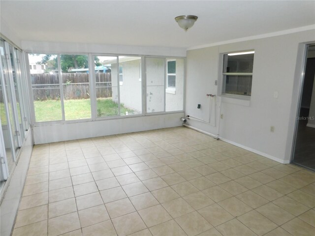 4417 Kohler St, New Port Richey, FL 34652 - unfurnished sunroom featuring tile patterned floors