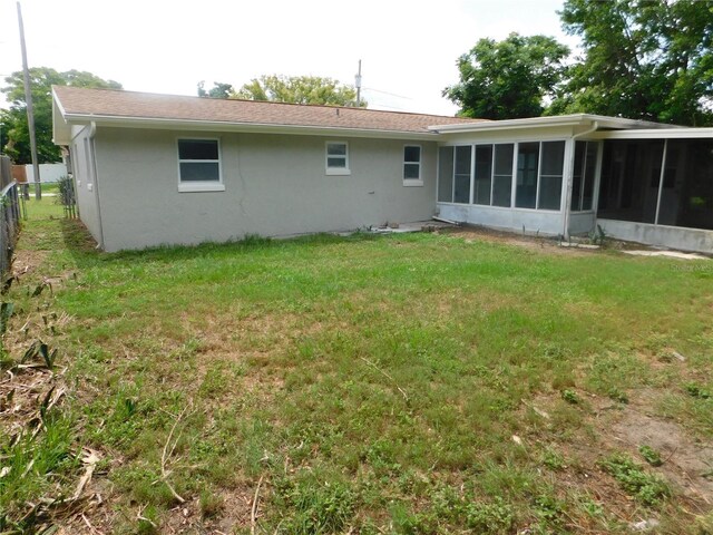 4417 Kohler St, New Port Richey, FL 34652 - back of property with a sunroom and stucco siding