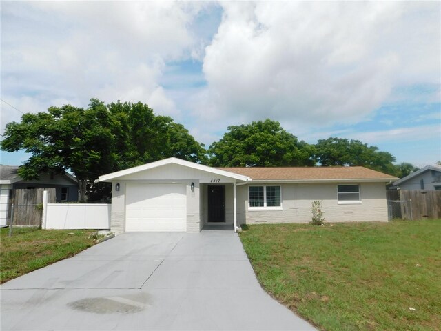4417 Kohler St, New Port Richey, FL 34652 - ranch-style house featuring an attached garage, driveway, stucco siding, and stone siding