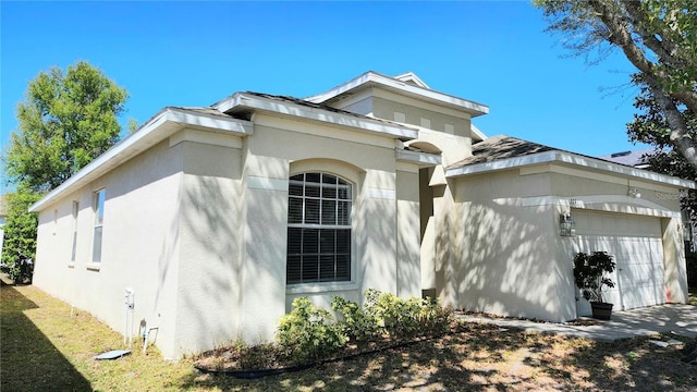 221 Fairmont Dr, Spring Hill, FL 34609 - view of home's exterior featuring a garage and stucco siding