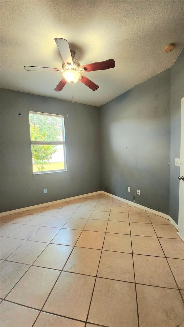 221 Fairmont Dr, Spring Hill, FL 34609 - spare room featuring a textured ceiling, light tile patterned floors, and ceiling fan