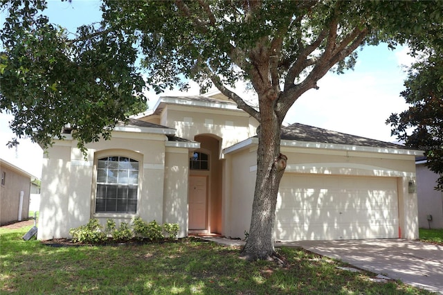 221 Fairmont Dr, Spring Hill, FL 34609 - view of front facade featuring a garage, stucco siding, and concrete driveway