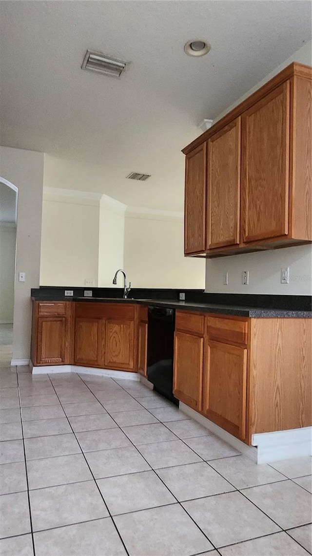 221 Fairmont Dr, Spring Hill, FL 34609 - kitchen with dishwasher, brown cabinetry, ornamental molding, dark countertops, and light tile patterned floors