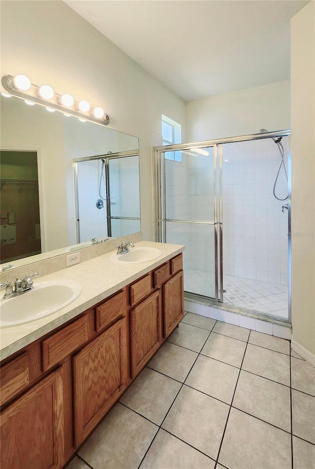 221 Fairmont Dr, Spring Hill, FL 34609 - bathroom with a shower stall, double vanity, tile patterned flooring, and a spacious closet