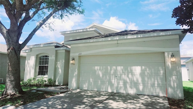 221 Fairmont Dr, Spring Hill, FL 34609 - view of front of house featuring a garage, concrete driveway, and stucco siding