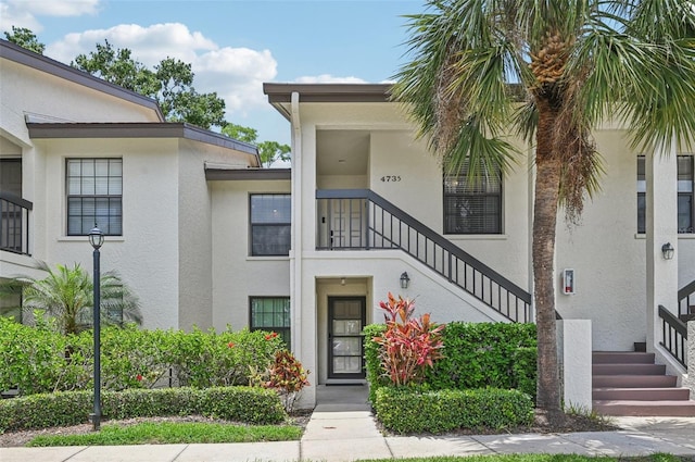 4735 Winslow Beacon Unit 14, Sarasota, FL 34235 - view of front of property with stairs and stucco siding