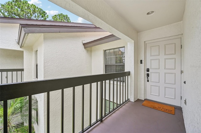 4735 Winslow Beacon Unit 14, Sarasota, FL 34235 - property entrance featuring a balcony and stucco siding