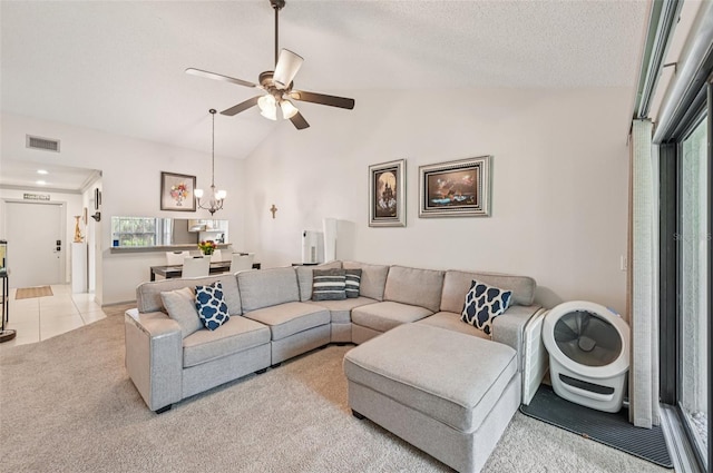 4735 Winslow Beacon Unit 14, Sarasota, FL 34235 - living area with ceiling fan, light carpet, vaulted ceiling, a chandelier, and light tile patterned floors