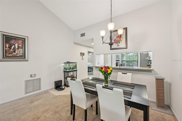 4735 Winslow Beacon Unit 14, Sarasota, FL 34235 - dining area featuring high vaulted ceiling, a chandelier, and carpet floors