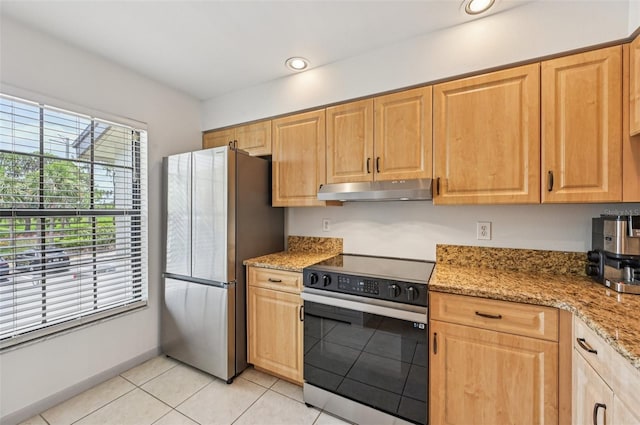 4735 Winslow Beacon Unit 14, Sarasota, FL 34235 - kitchen with electric range, freestanding refrigerator, under cabinet range hood, light tile patterned flooring, and light stone counters