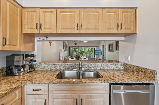 4735 Winslow Beacon Unit 14, Sarasota, FL 34235 - kitchen with stainless steel dishwasher, light brown cabinets, and light stone counters