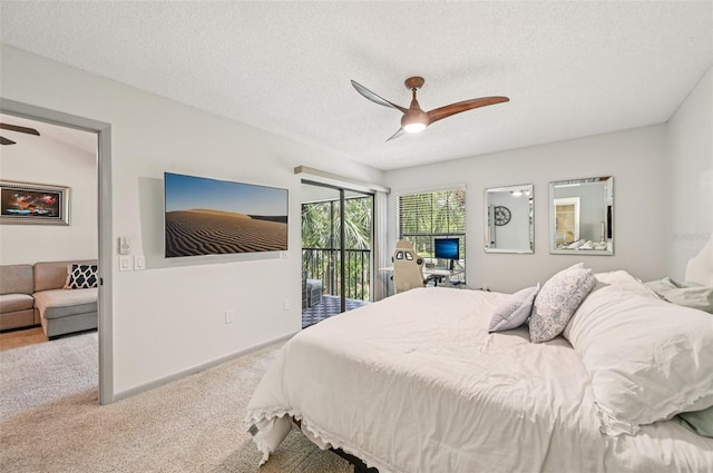 4735 Winslow Beacon Unit 14, Sarasota, FL 34235 - bedroom with access to outside, carpet floors, ceiling fan, and a textured ceiling