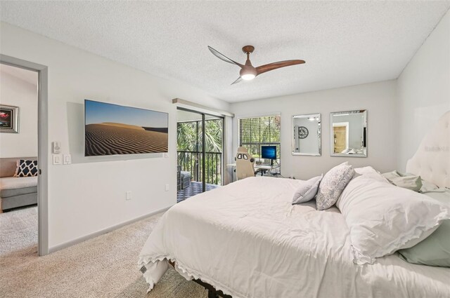 4735 Winslow Beacon Unit 14, Sarasota, FL 34235 - bedroom featuring access to exterior, carpet flooring, a textured ceiling, and ceiling fan