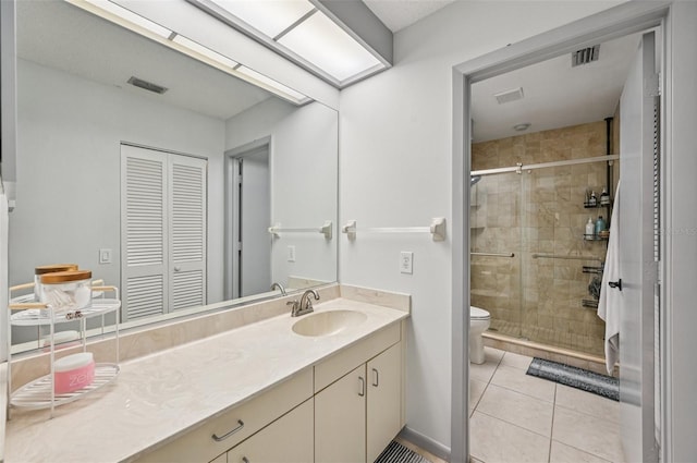 4735 Winslow Beacon Unit 14, Sarasota, FL 34235 - bathroom with a closet, vanity, a stall shower, and tile patterned flooring