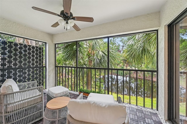 4735 Winslow Beacon Unit 14, Sarasota, FL 34235 - sunroom with a ceiling fan, a water view, and an outdoor hangout area