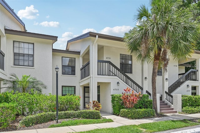 4735 Winslow Beacon Unit 14, Sarasota, FL 34235 - view of front of home featuring stairs and stucco siding