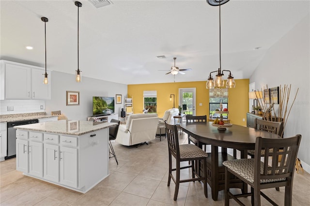 12004 Legacy Bright St, Riverview, FL 33578 - kitchen featuring stainless steel dishwasher, a ceiling fan, tasteful backsplash, a kitchen island, and white cabinets