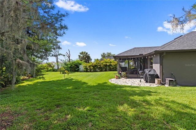 12004 Legacy Bright St, Riverview, FL 33578 - view of green lawn featuring a patio area and a sunroom