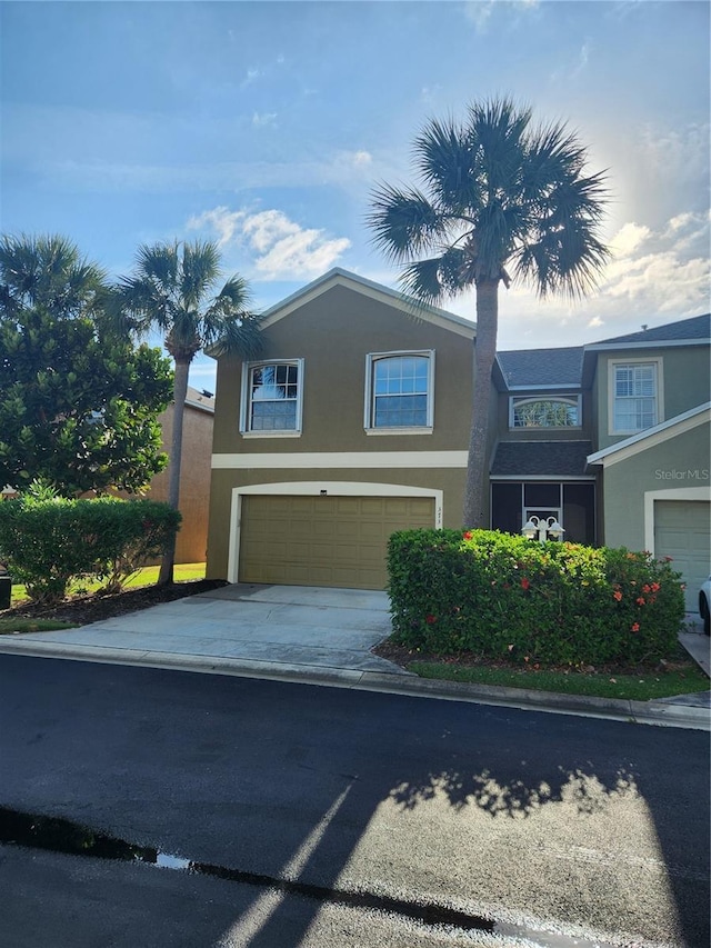 373 Intrepid Way, Indialantic, FL 32903 - traditional-style house featuring stucco siding, a garage, and concrete driveway