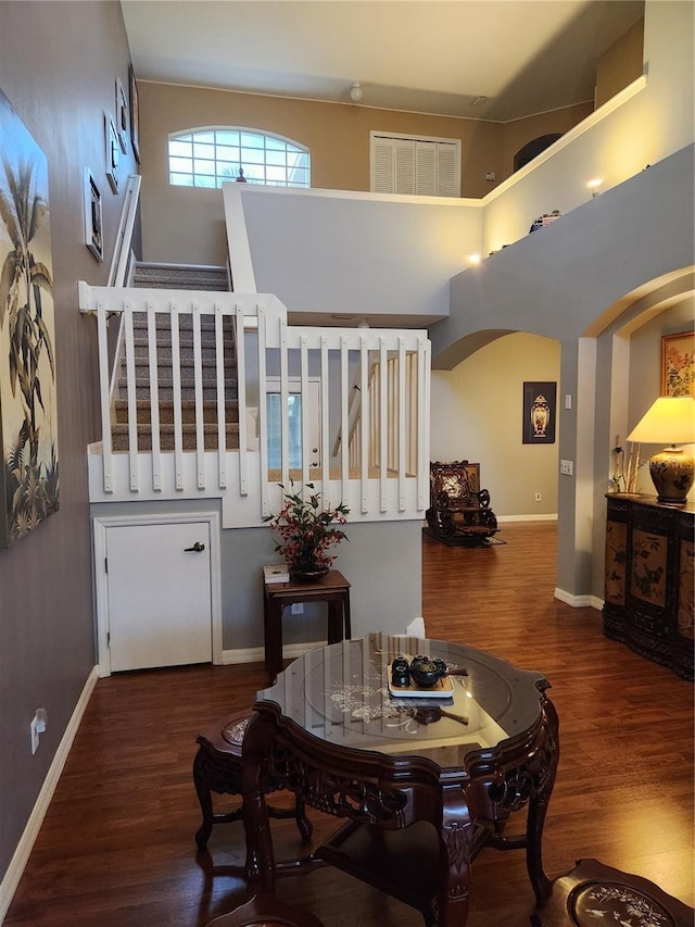 373 Intrepid Way, Indialantic, FL 32903 - dining room with arched walkways, wood finished floors, stairway, and baseboards
