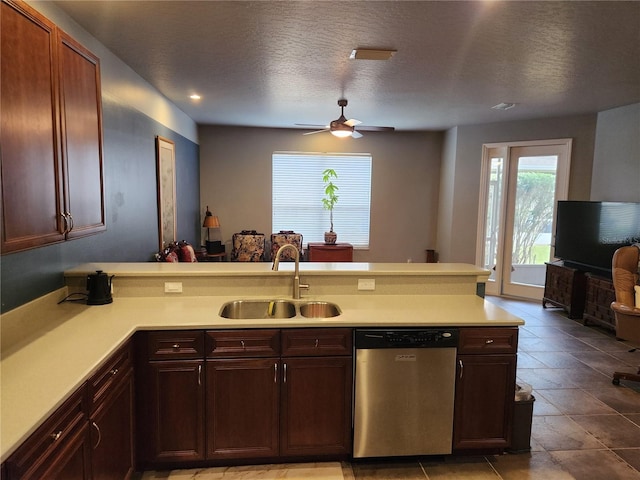 373 Intrepid Way, Indialantic, FL 32903 - kitchen with stainless steel dishwasher, a sink, a peninsula, light countertops, and a textured ceiling