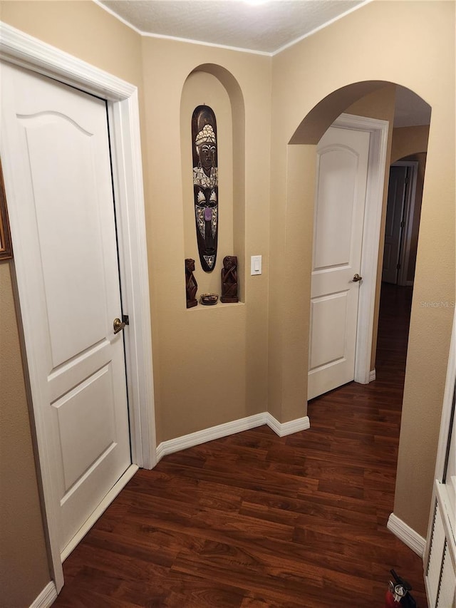 373 Intrepid Way, Indialantic, FL 32903 - corridor with dark wood-type flooring, baseboards, and arched walkways