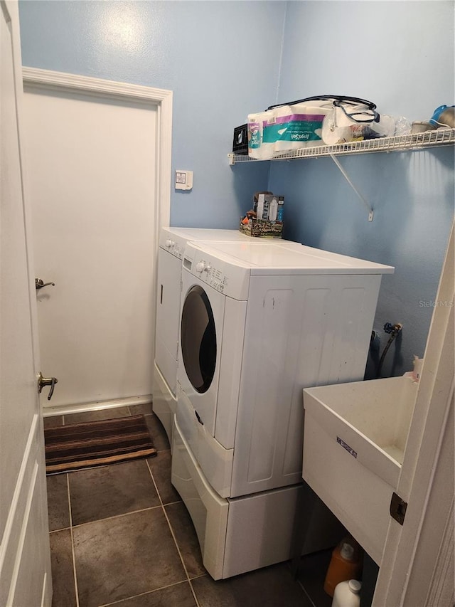 373 Intrepid Way, Indialantic, FL 32903 - washroom with washer and clothes dryer and dark tile patterned floors