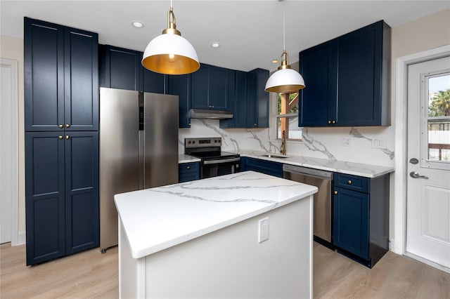 13148 3rd St E, Madeira Beach, FL 33708 - kitchen featuring appliances with stainless steel finishes, blue cabinets, under cabinet range hood, light wood-type flooring, and a kitchen island